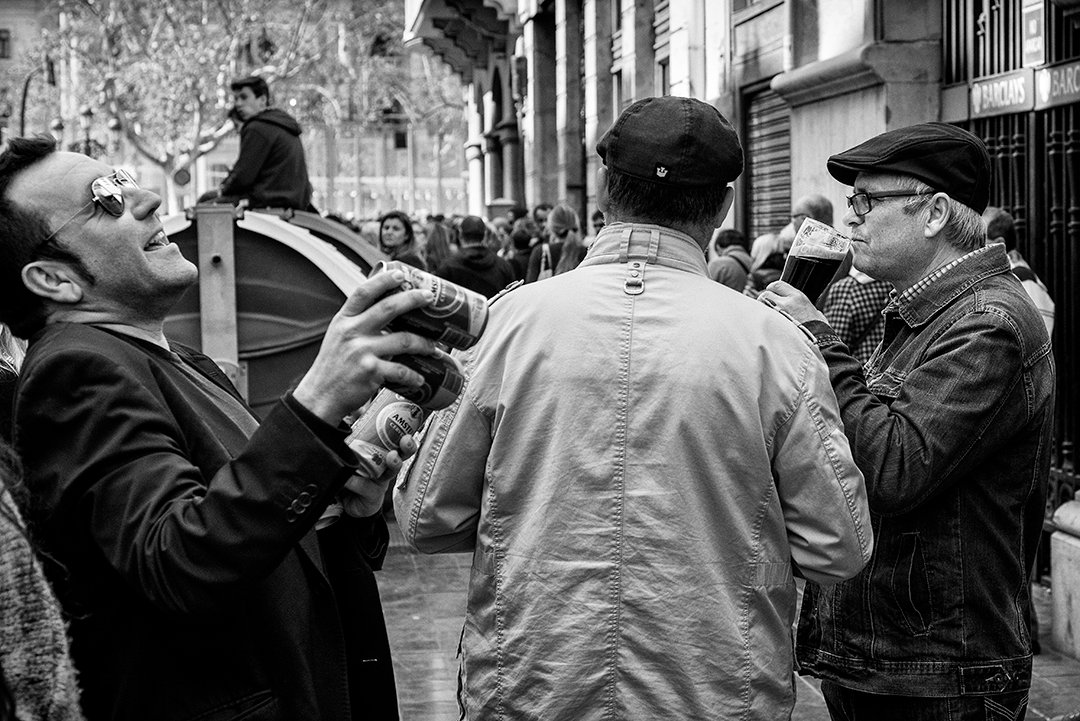 Men playing instruments on a street during a celebration.